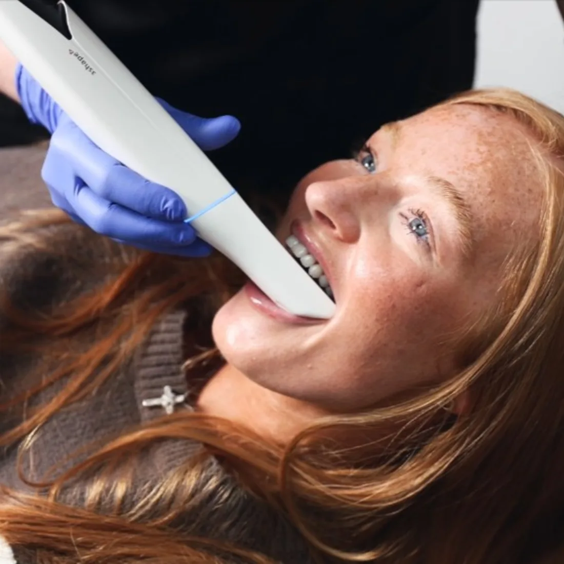 Queensway dentist assessing a patient's smile for whitening Queensway dentist assessing a patient's smile for whitening